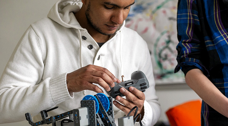 Student building a mechanical robot