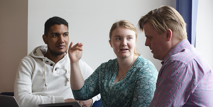 Students pondering a group task while sitting