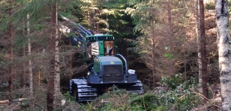 A forest harvesting machine working among trees in Evo, Finland.