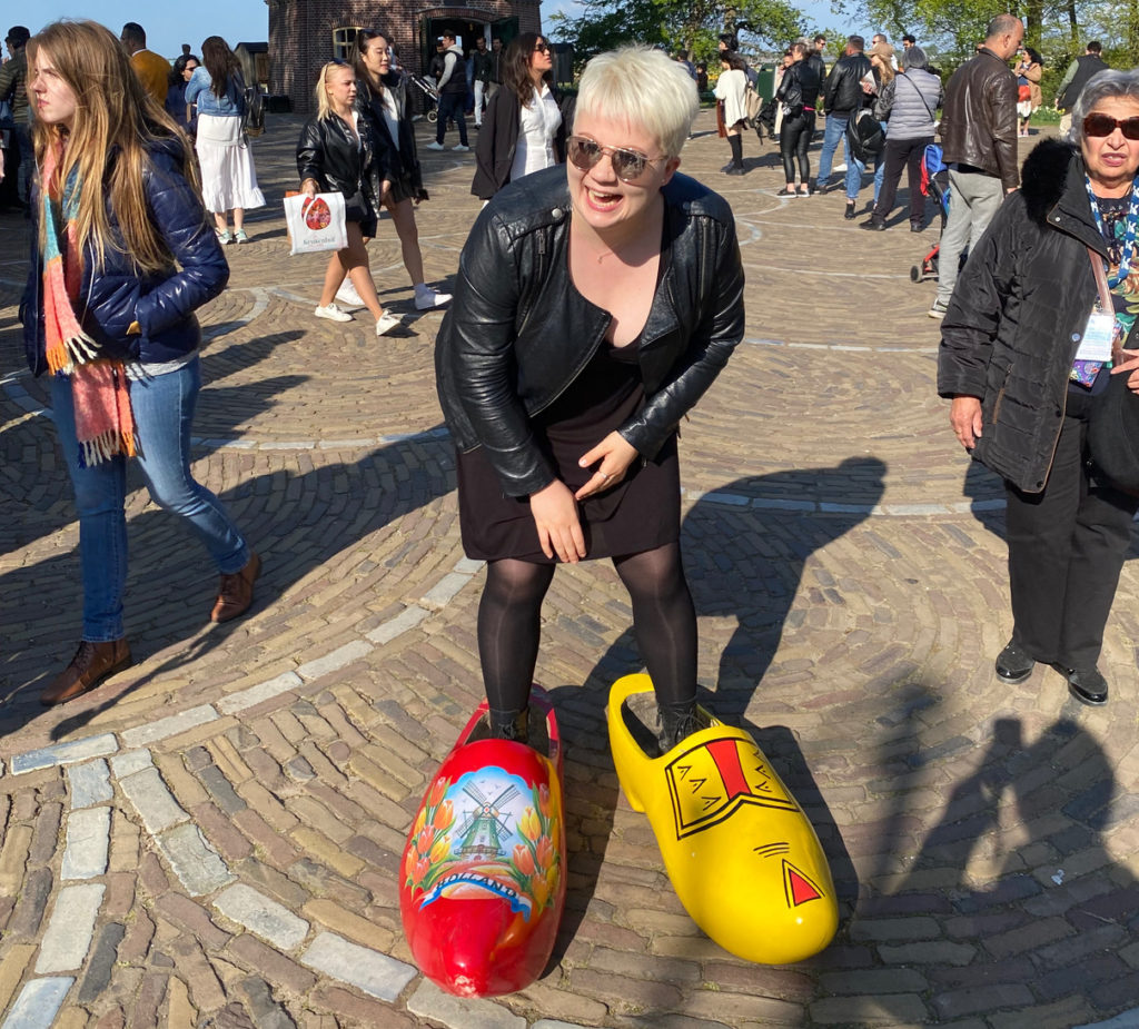 Student laughing and wearing big clogs