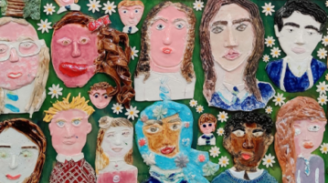 Students faces painted in a mural