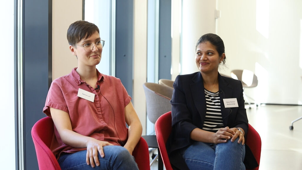 Sabrina and Oshani sitting and smiling