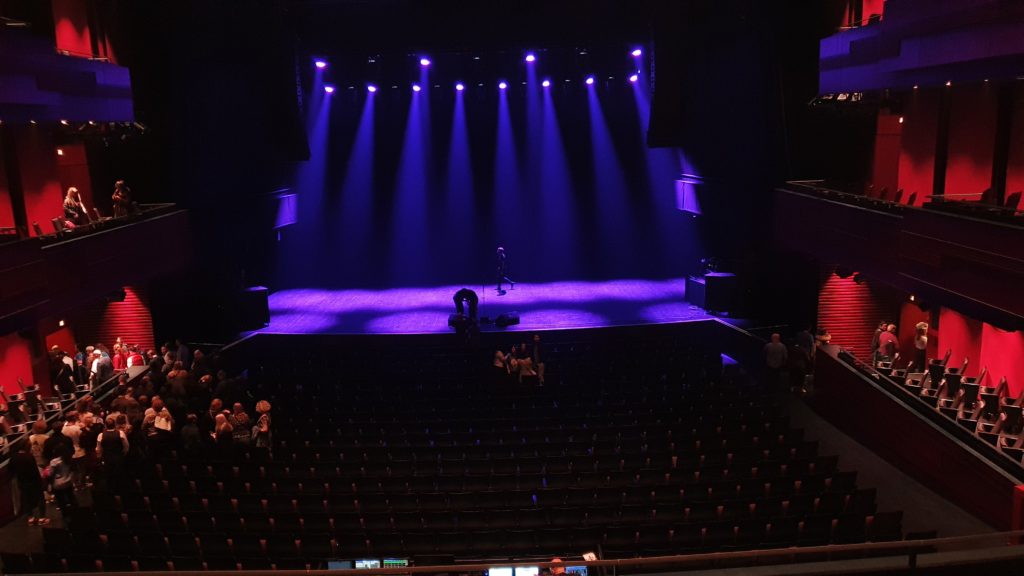 A concert hall with dimmed lights 