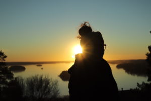 Isabel in sunset. In the background a beautiful lake landscape.